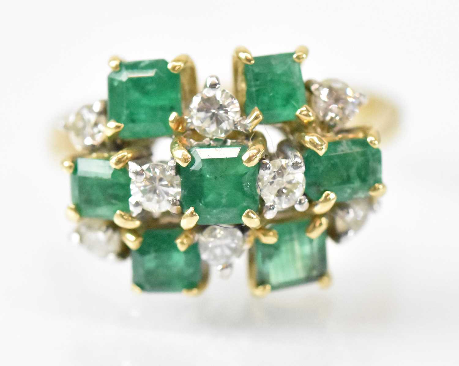 An 18ct yellow gold diamond and emerald cluster ring set with seven square cut rubies and eight