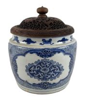 An 18th century Kangxi period blue and white decorated jar with carved hardwood cover, double ring