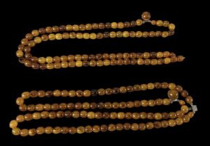 Two double strands of amber coloured beads, length 53cm.