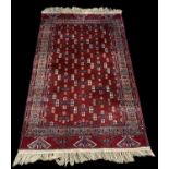 A modern red ground Persian style carpet with geometric design, 184 x 113cm.