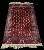 A modern red ground Persian style carpet with geometric design, 184 x 113cm.