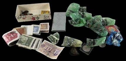 A quantity of all world coins and banknotes including pennies, euros, threepenny bits, sixpences,