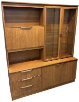 A teak mid century wall unit, with pair of glazed doors and fall front cupboard above pair of