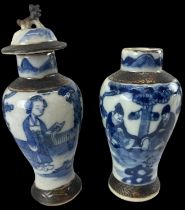 A pair of late 19th/early 20th century Chinese blue and white porcelain lidded vases (one lacking