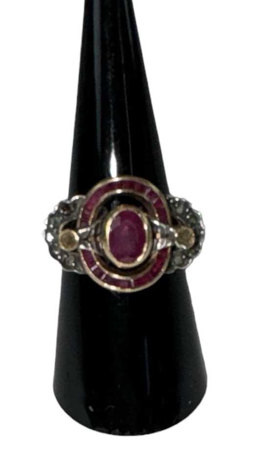 A yellow metal Art Deco style ruby and diamond set ring, the central ruby approx 0.75ct,