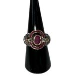 A yellow metal Art Deco style ruby and diamond set ring, the central ruby approx 0.75ct,