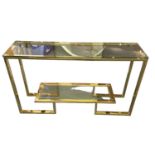 A modern brass framed two tier glass topped hall table, width 130cm.