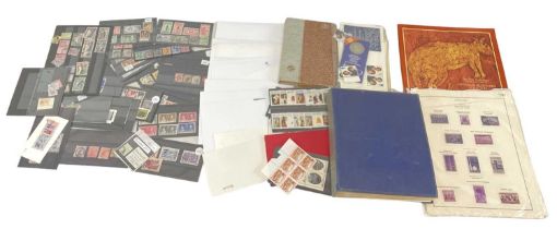 A folder of albums and cards of mainly Commonwealth stamps.
