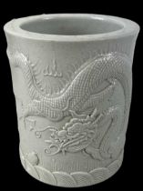 A modern Chinese brush pot decorated with a dragon, four character mark to base, height 14cm,