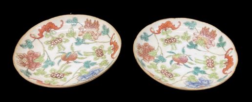 A pair of Chinese hand painted porcelain floral decorated saucers, four character mark to base,