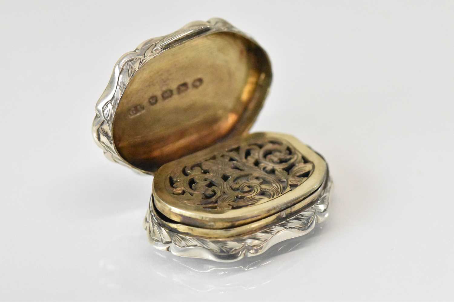 GEORGE UNITE; a Victorian hallmarked silver shaped oval vinaigrette with pierced gilt interior, - Image 2 of 4