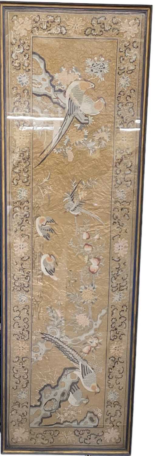 A 19th century Chinese silk embroidery of birds amongst foliage, the border decorated with scrolling