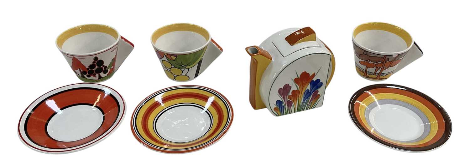 BRADFORD EXCHANGE; a Clarice Cliff 'Bizarre' painted 'Trees and House' pattern teacup and saucer,