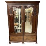 An early 20th century mahogany wardrobe, with pair of mirrored doors above pair of drawers, height