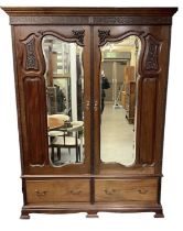 An early 20th century mahogany wardrobe, with pair of mirrored doors above pair of drawers, height