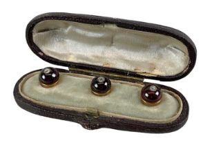 A Victorian cased set of three garnet and diamond set studs. Condition Report: Box clasp does not