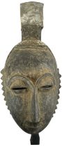 A Baule portrait mask, height 40cm, width approx 18cm.