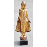 A large 18th century Sino-Tibetan bronzed giltwood figure, height 116 cms including base.