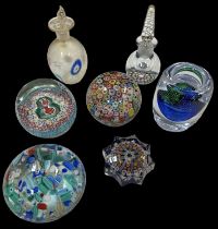 A group of three Murano glass paperweights, a Strathern paperweight, a Bohemian glass candlestick (