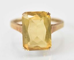 A 9ct yellow gold ring set with large central yellow stone, size M, approx 3.6g.