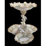 A Continental figural porcelain floral decorated centrepiece, height 38cm.