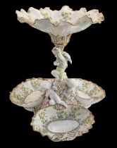 A Continental figural porcelain floral decorated centrepiece, height 38cm.