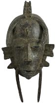 A bronze Senufo mask, height 30cm, width 15cm.