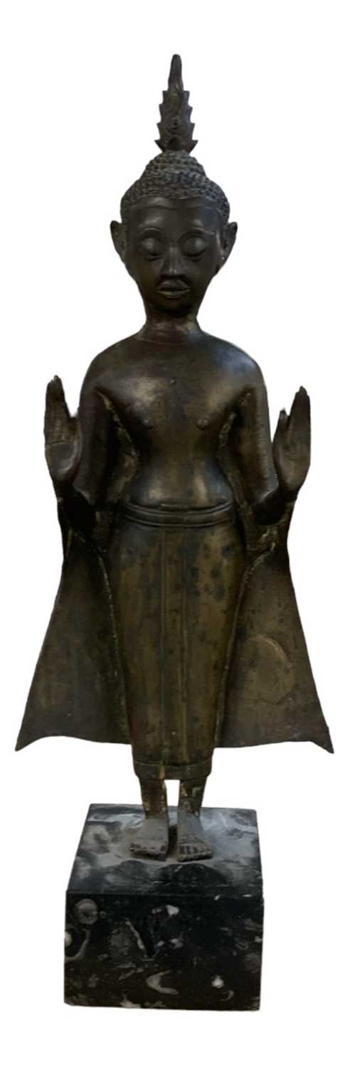 A late 19th century Thai figure of standing Buddha, raised on black marble base, height 48cm.