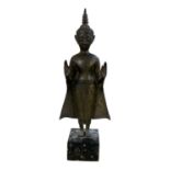 A late 19th century Thai figure of standing Buddha, raised on black marble base, height 48cm.