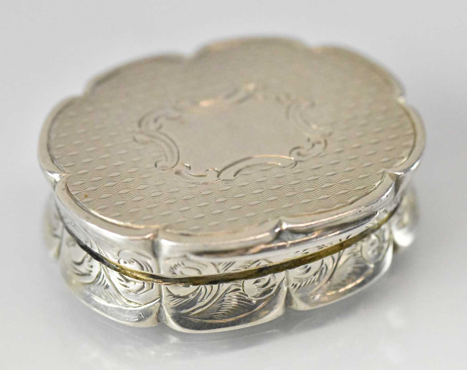 ROBERT THORNTON; a Victorian hallmarked silver shaped oval vinaigrette with gilt interior,