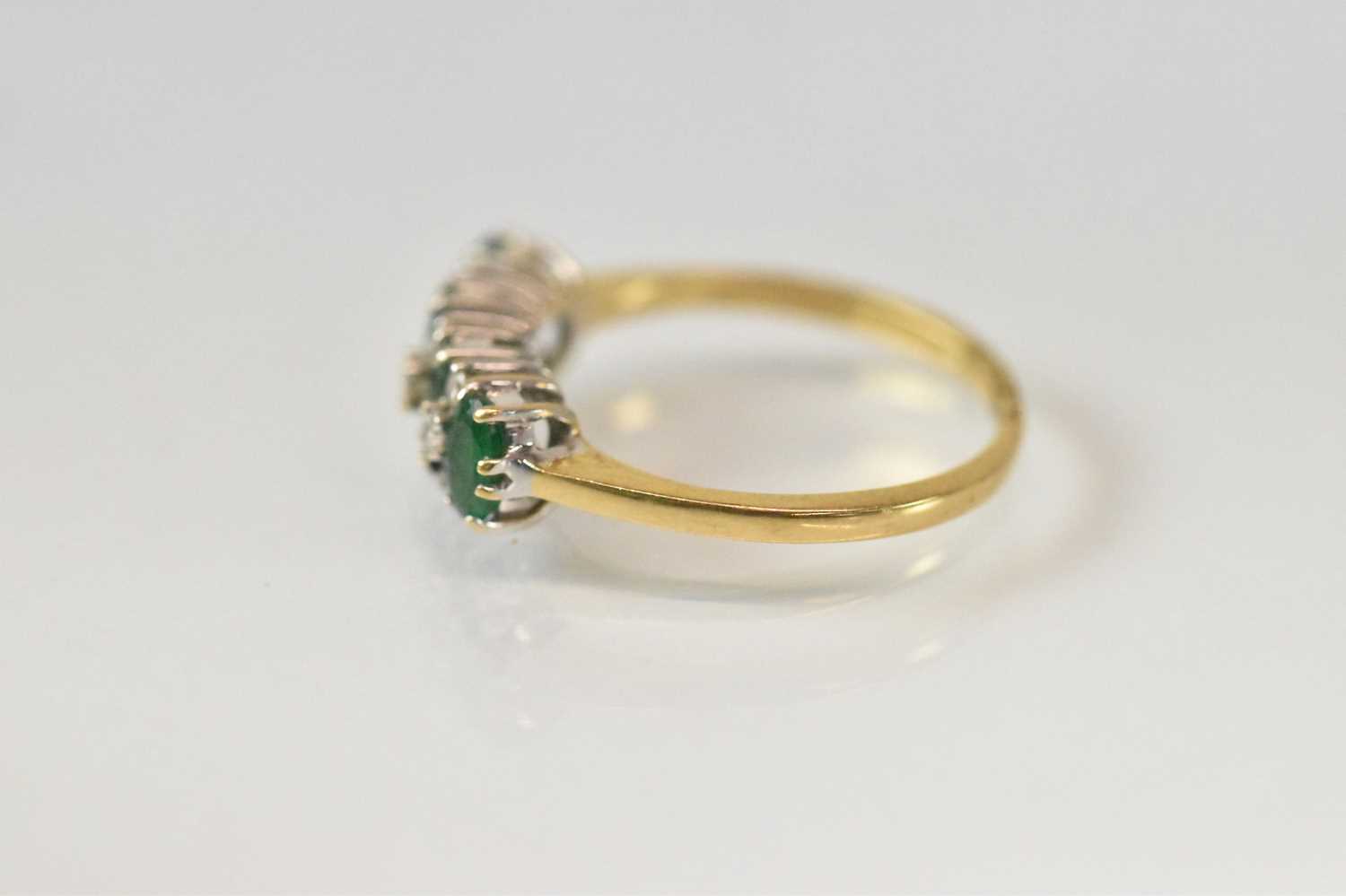 An 18ct yellow gold emerald and diamond ring set with four emeralds and nine small diamonds, size O, - Image 2 of 3