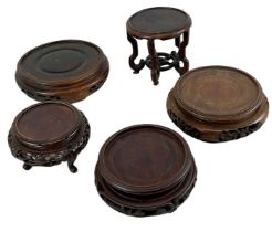 A group of five Chinese carved hardwood display stands.