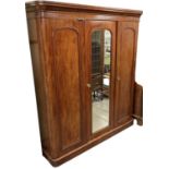 A Victorian mahogany three door wardrobe with central mirrored door, height 205cm, width 175cm.