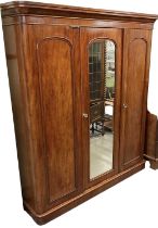 A Victorian mahogany three door wardrobe with central mirrored door, height 205cm, width 175cm.