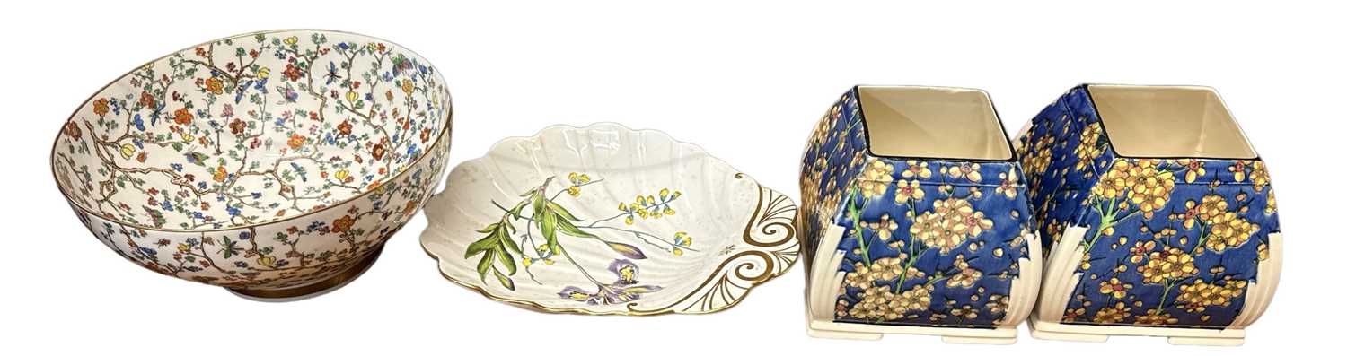 ROYAL DOULTON; a pair of early 20th century Art Deco style blue ground floral decorated vases,