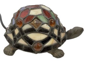 A Tiffany style bronzed metal tortoise lamp with coloured glass shade/shell, length 20cm. (af)