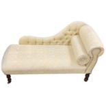 A reproduction mahogany cream upholstered chaise longue on turned supports, width approx 125cm.