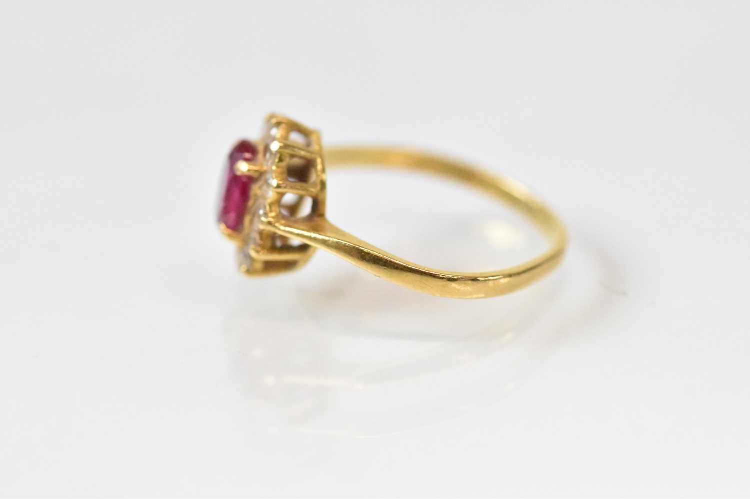 An 18ct yellow gold ruby and diamond set cluster ring, the central ruby approx 0.75ct, surrounded by - Image 2 of 3