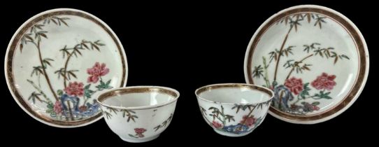 A pair of Chinese Yongzheng floral decorated porcelain tea bowls, diameter 7cm, with matching