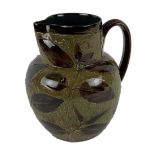 DOULTON LAMBETH; a large green and brown ground floral decorated stoneware jug, height 21.5cm.