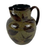 DOULTON LAMBETH; a large green and brown ground floral decorated stoneware jug, height 21.5cm.