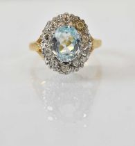 An 18ct yellow gold aquamarine and diamond set cluster ring, the central aquamarine approx 2ct and