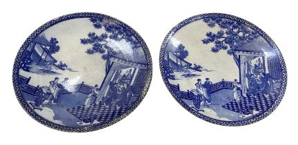 A pair of modern Japanese blue and white porcelain chargers, decorated with figures amongst