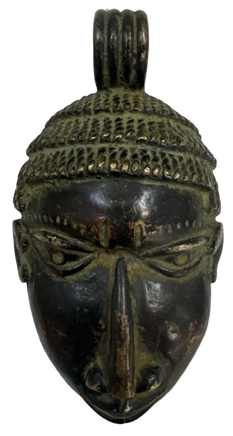 An African bronze tribal pendant modelled as a face, height 14.5cm, width 8cm.