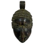 An African bronze tribal pendant modelled as a face, height 14.5cm, width 8cm.