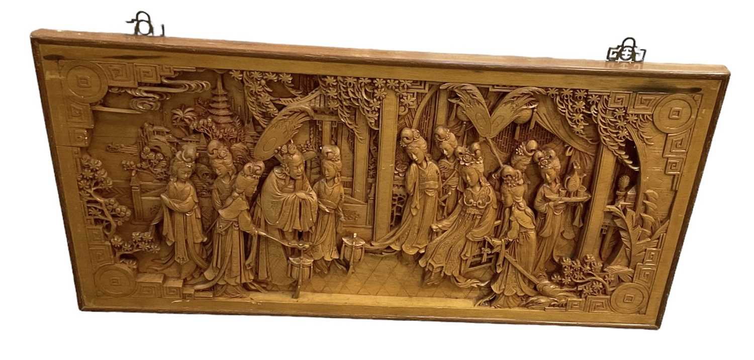 A large modern Chinese carved wooden wall hanging plaque showing ladies amongst foliage, 50 x