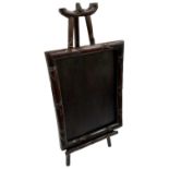 A Chinese carved hardwood easel, with a carved hardwood bamboo effect mirror frame, frame measures