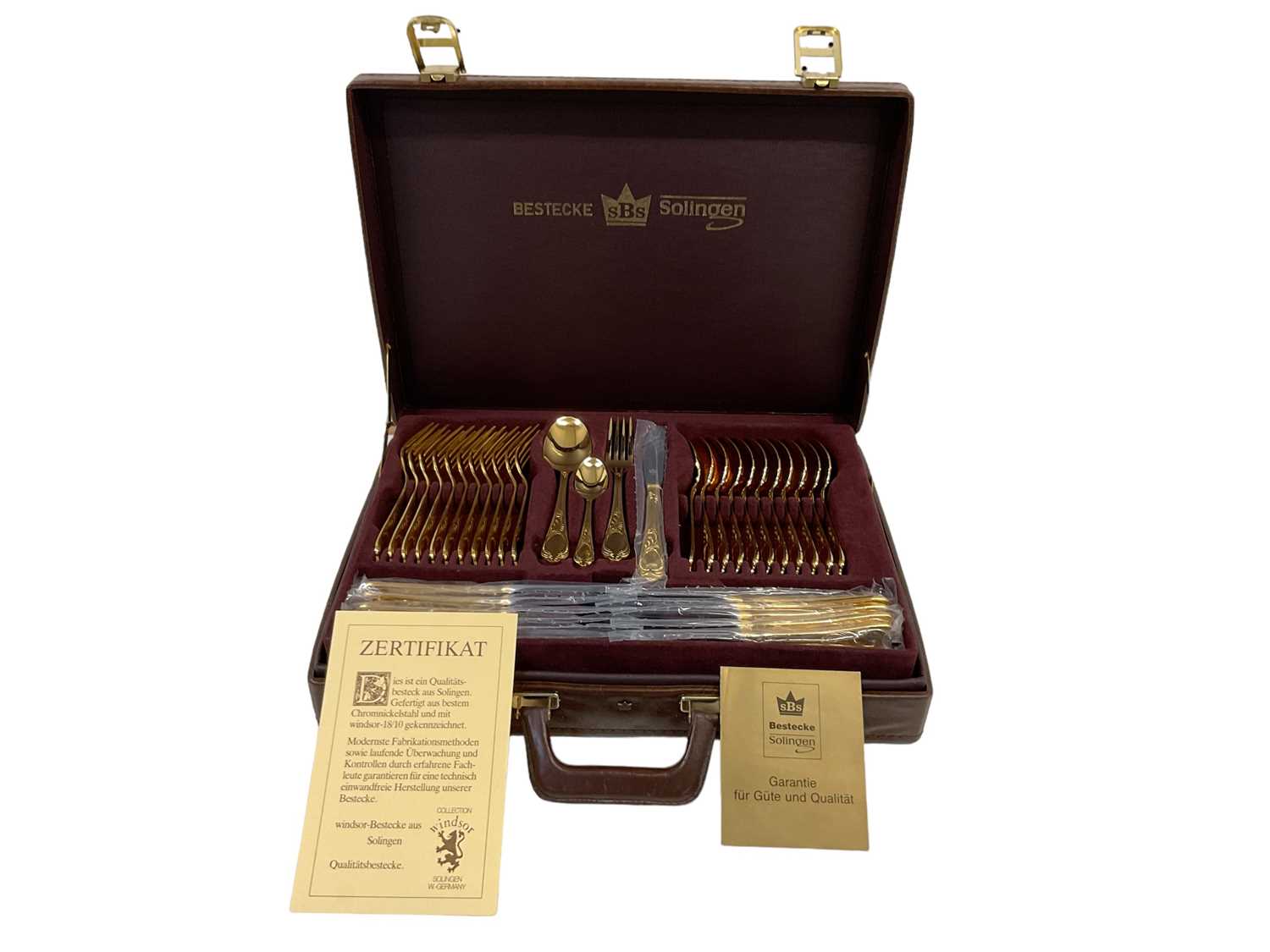 BESTECKE SOLINGEN; a leather cased twelve setting canteen of gold plated cutlery, stamped '23/24