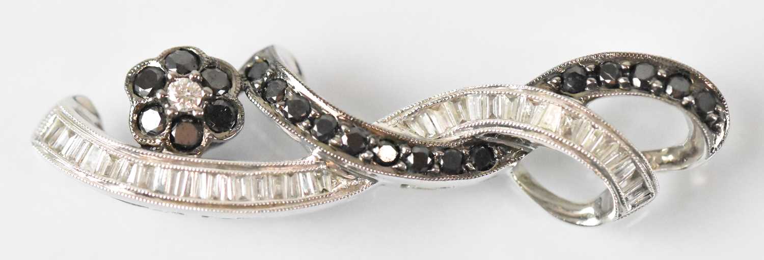 A 15ct white gold black and white diamond set brooch, length 4cm, approx 4.6g.