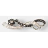 A 15ct white gold black and white diamond set brooch, length 4cm, approx 4.6g.
